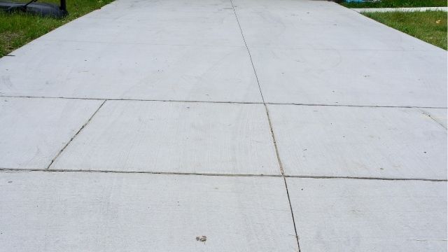 What are the pros and cons of a concrete driveway?